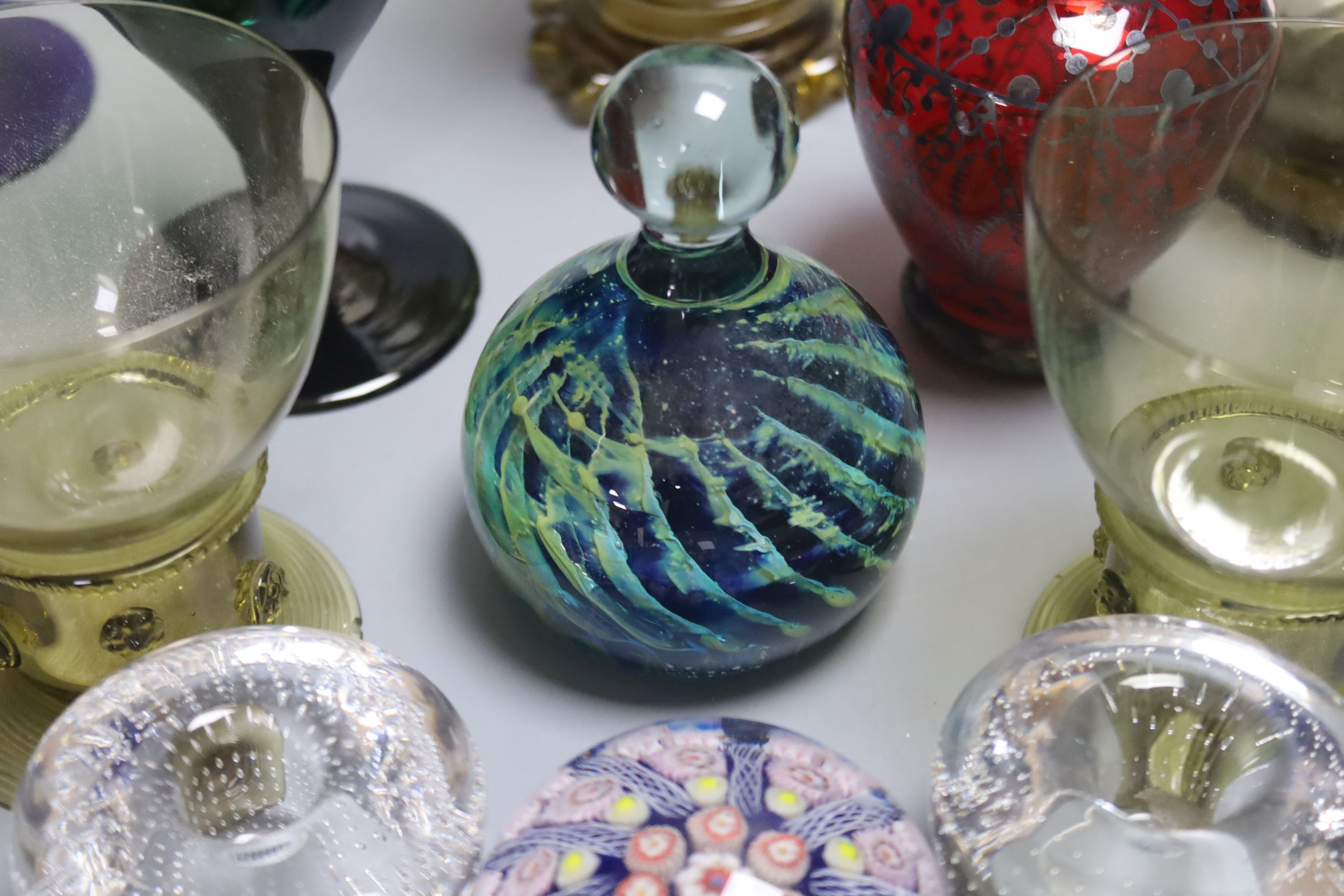 A German glass beaker with enamelled crest, 17.5cm, four Roemers, a millefiori paperweight and coloured glassware